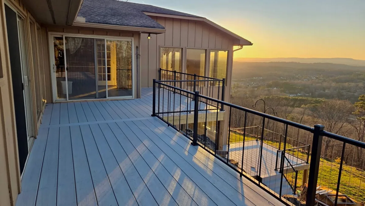 Black Westbury VertiCable railing on an elevated deck overlooking the hills at sunset